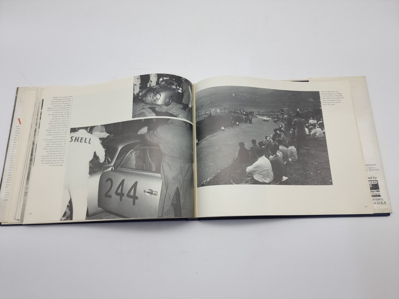 Signed hardcover book open to black-and-white photo spreads