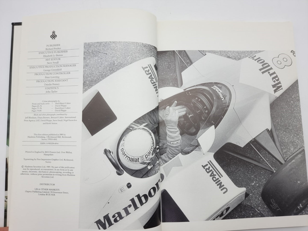 Motorsport book opened to page with title list and black-and-white car photo