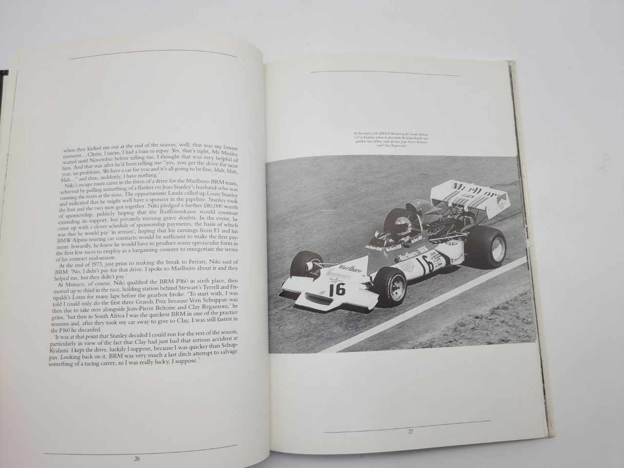 Motorsport book opened to pages with text and black-and-white race car image