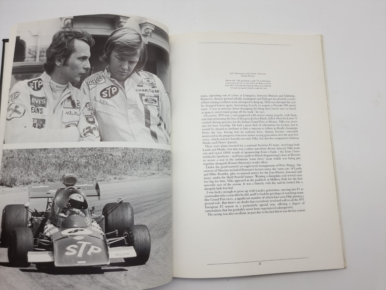 Motorsport book opened to photo spread of racers and an illustrated racing scene