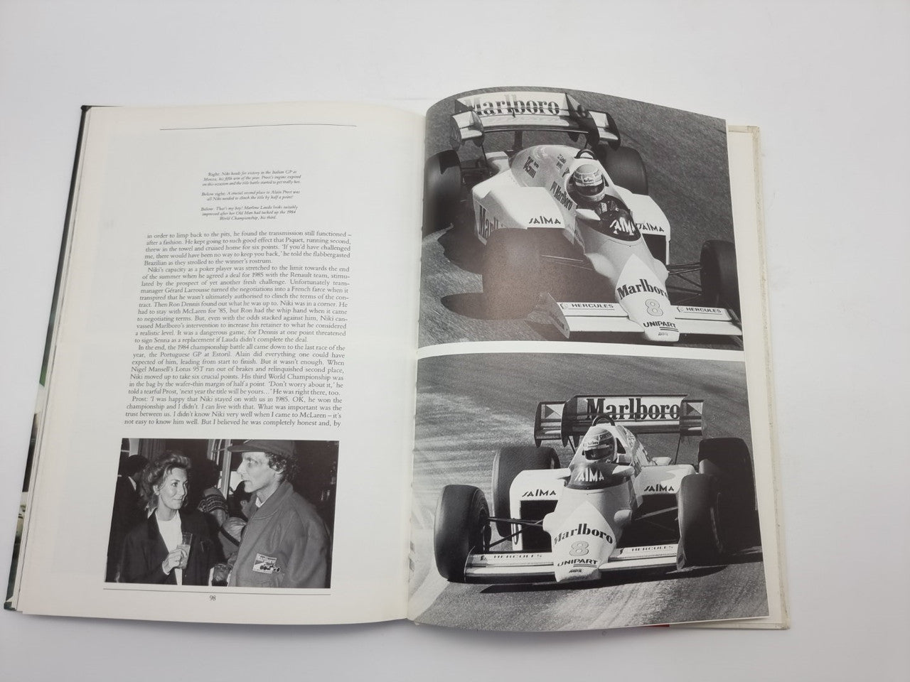 Motorsport book opened to black-and-white race photos across two pages