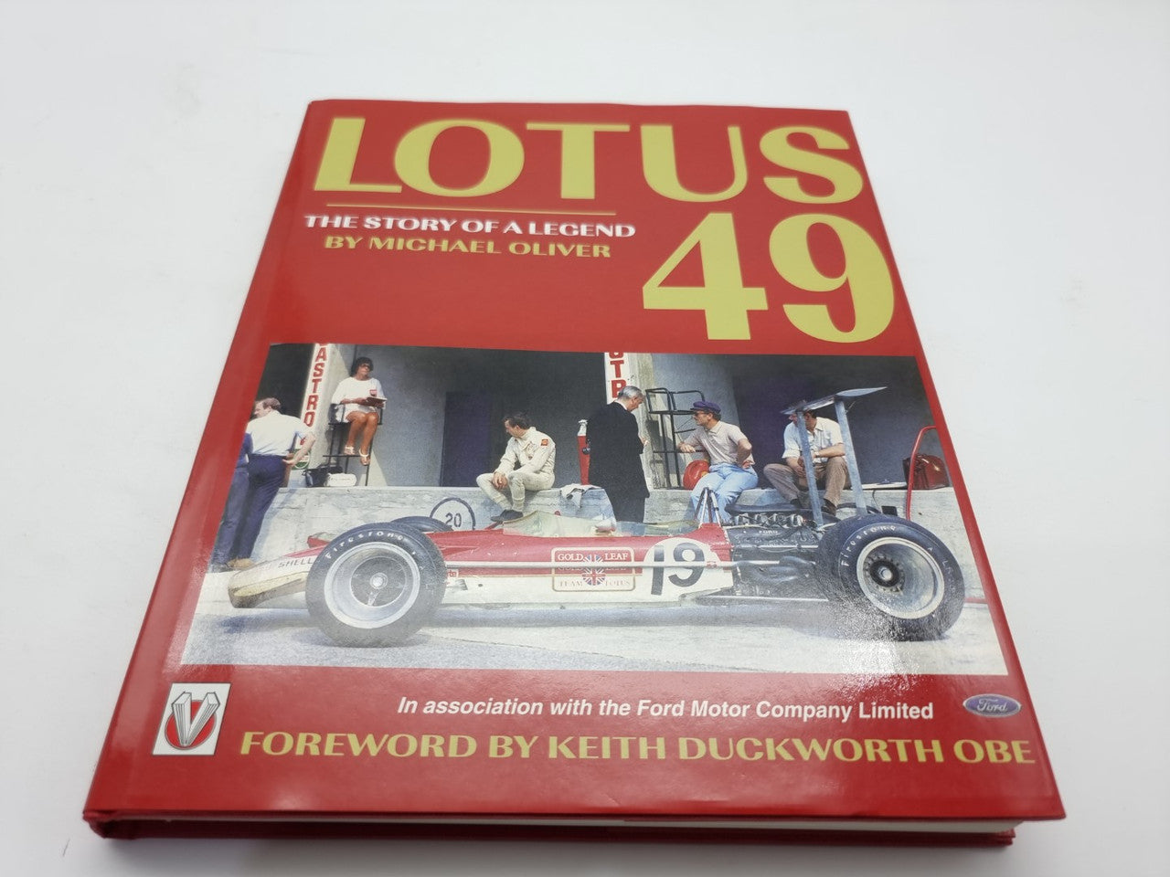 Red Lotus racing car history book with '49' on front cover, hardcover