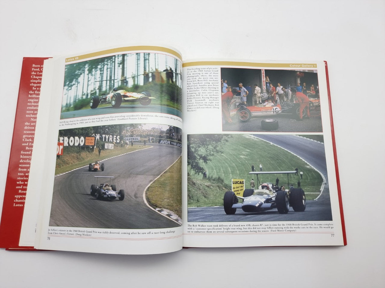 Open book showing race car photos across two pages on white paper