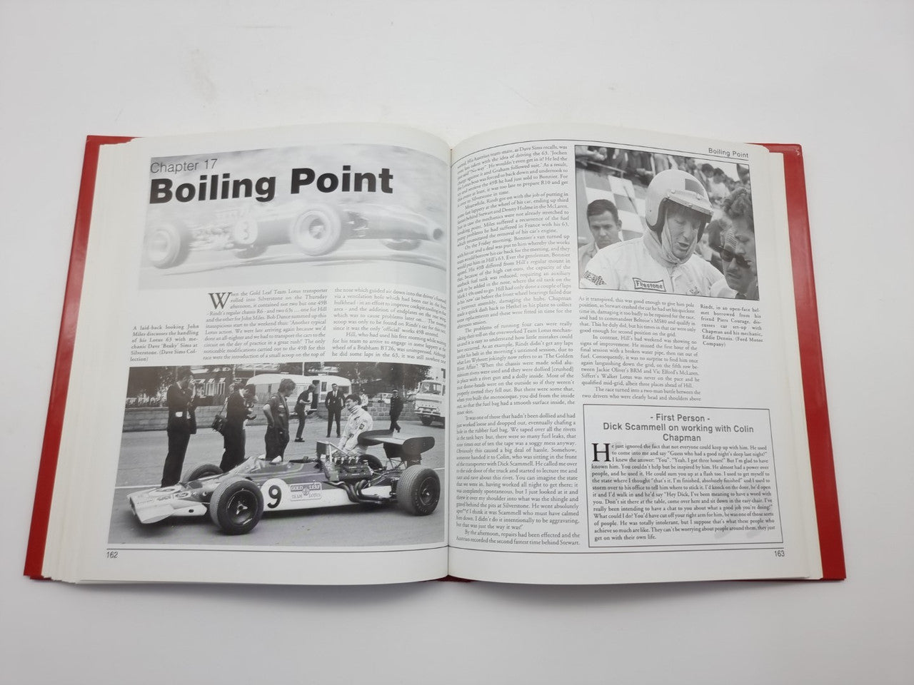 Open hardcover book with red cover, black text and photo spread with a racing car