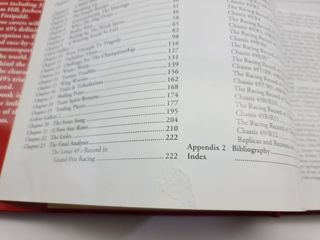 Open hardcover book page close-up with index list and section headings in small print