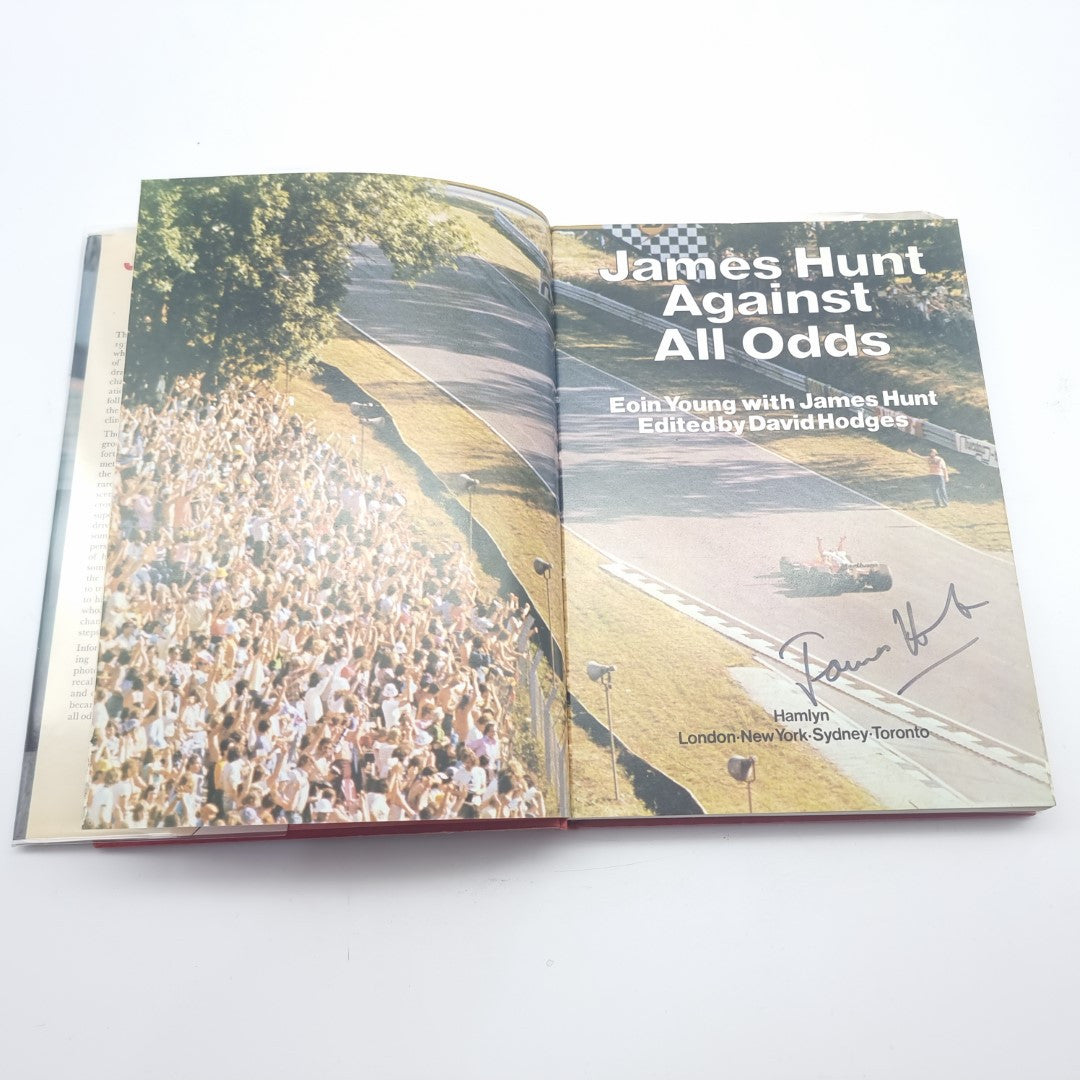 Racing memoir book open spread with crowd photo and front cover-style page layout