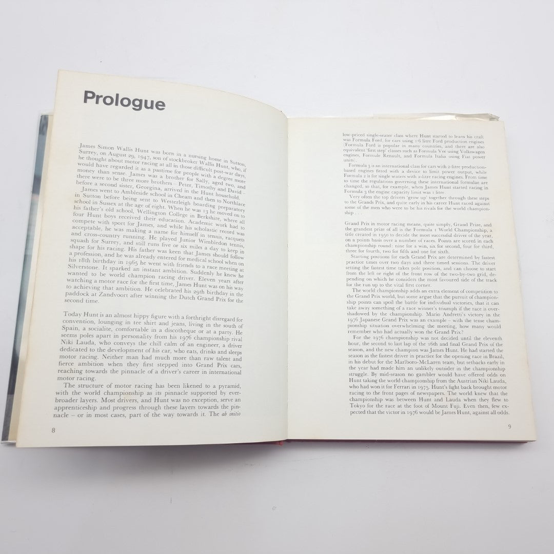 Signed racing memoir book, open to prologue pages with printed text