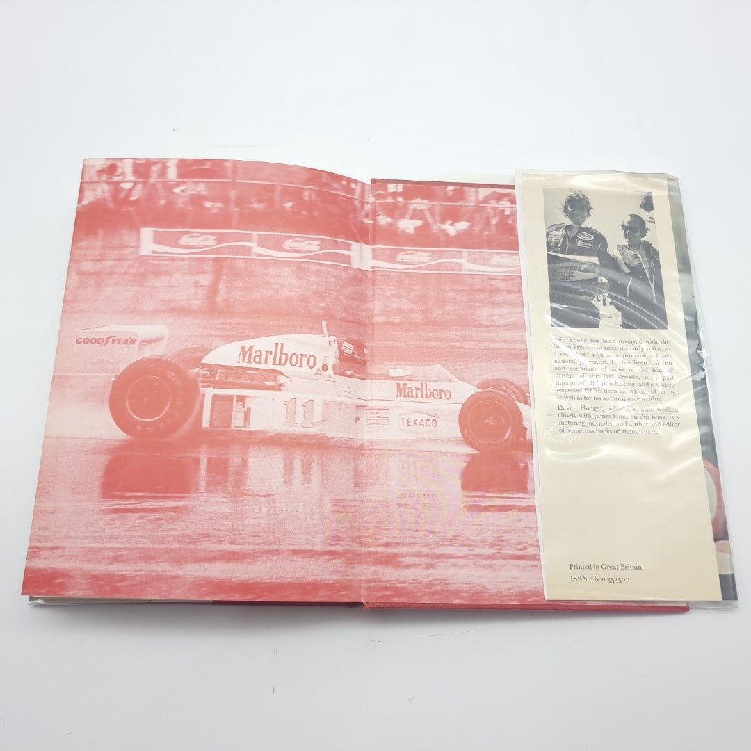 Racing memoir book page spread with red race car photo and a small inserted page
