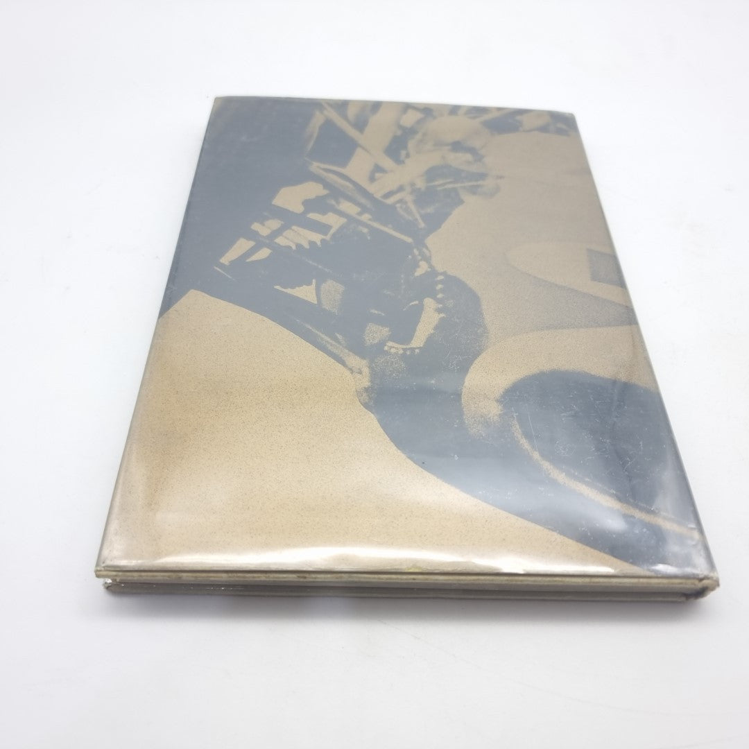 Motor race photography book back cover with racing car graphics and muted title text.