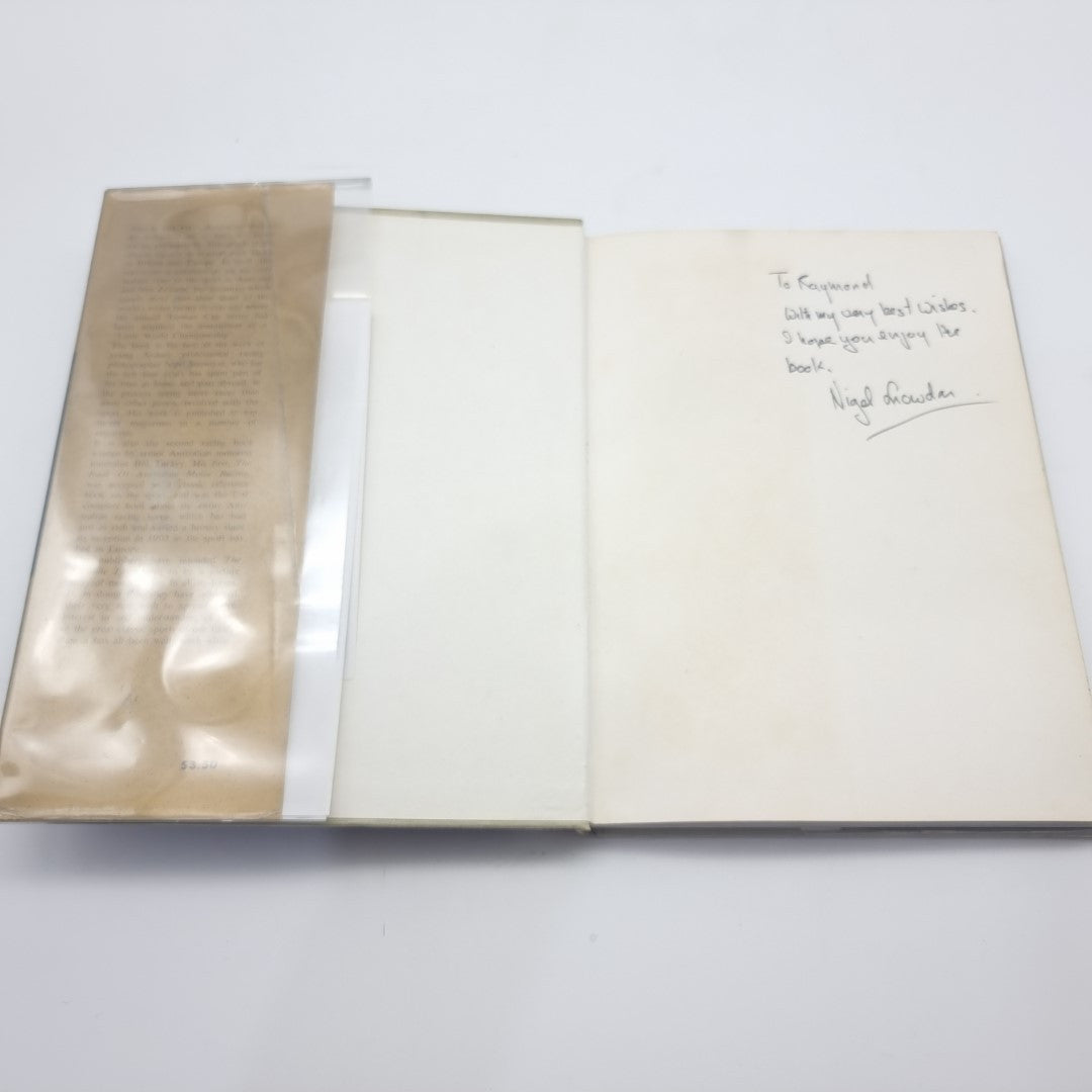 Motor race photography book opened, showing blank pages and an envelope-like insert.
