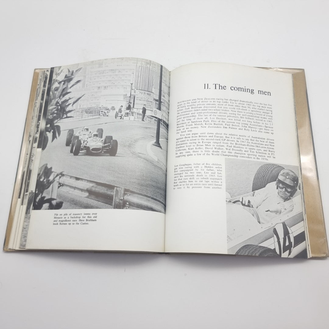 Signed motorsport photography book, open spread with track photos and printed chapter text