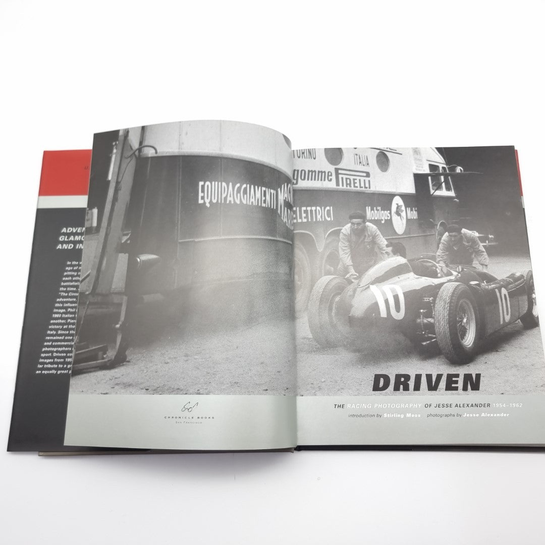 Racing photography book open spread showing race cars and crew photos