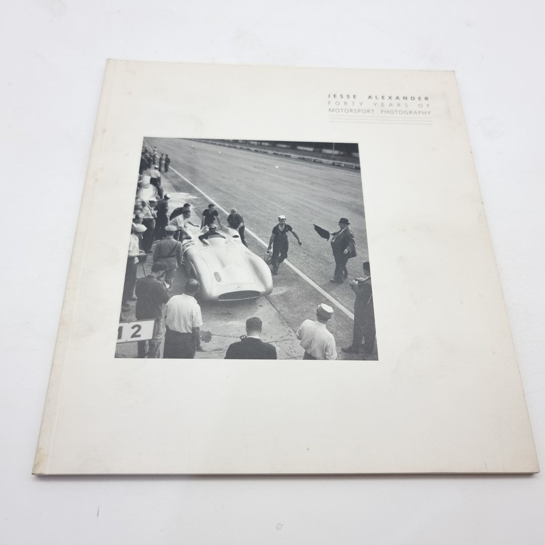 Motor racing photography book with white cover and black-and-white race track photo