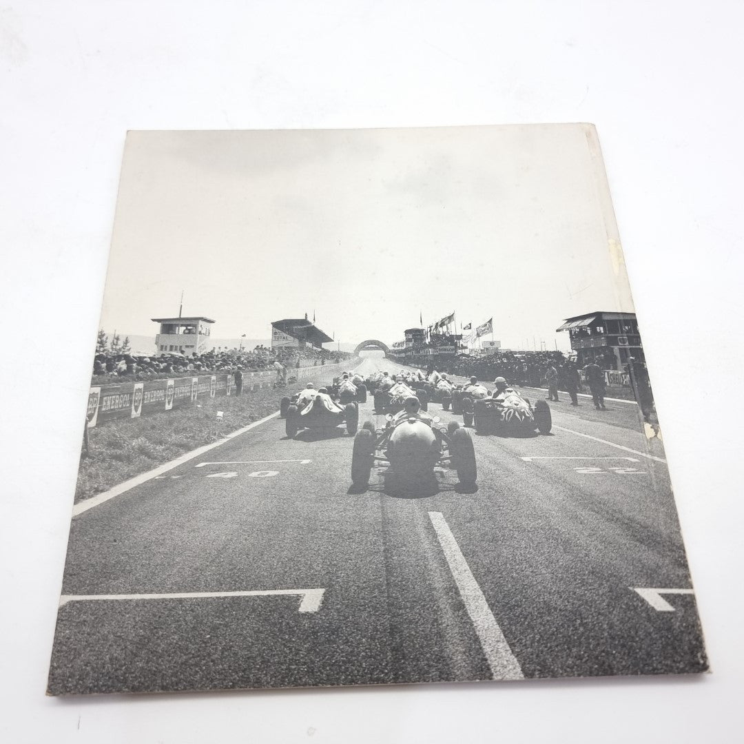 Motor racing photography book open with large black-and-white track photo