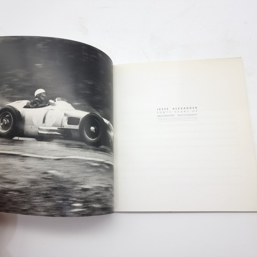 Motor racing photography book open showing vintage race car action photo