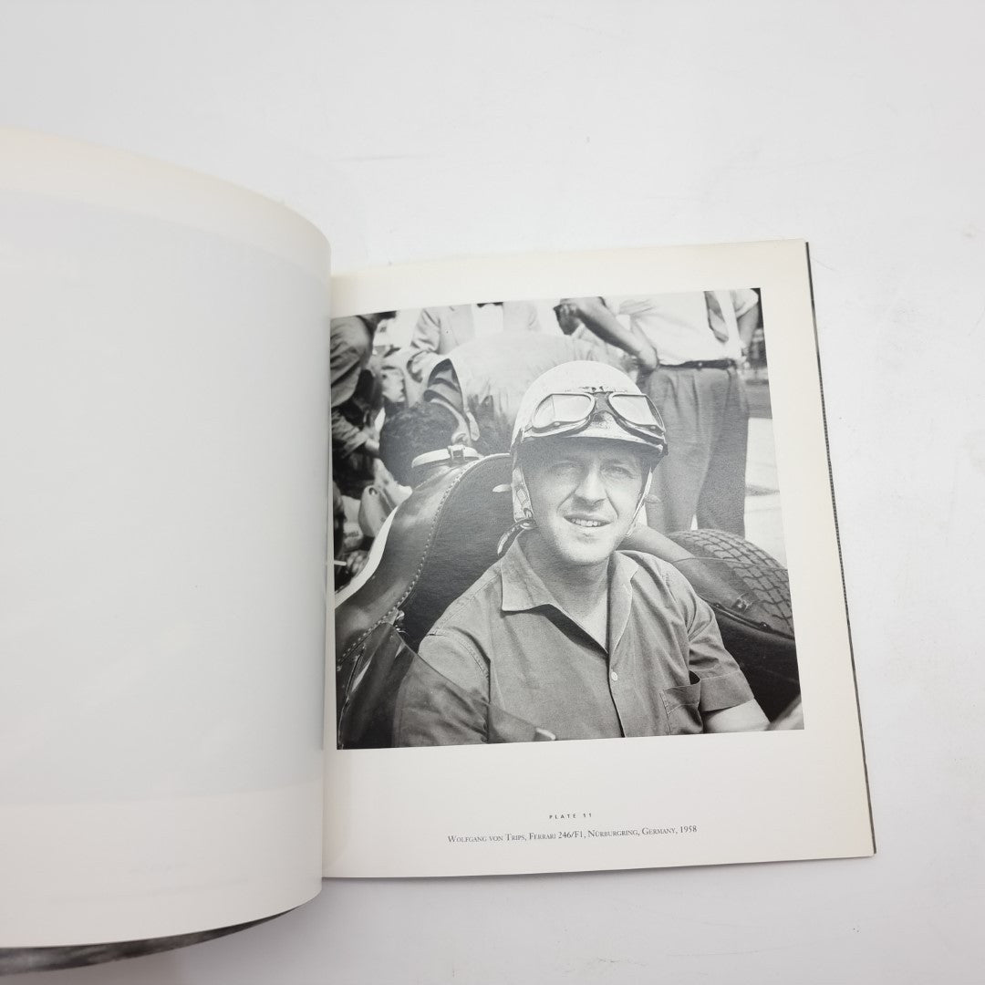 Motor racing photography book open with black-and-white portrait photo of a driver
