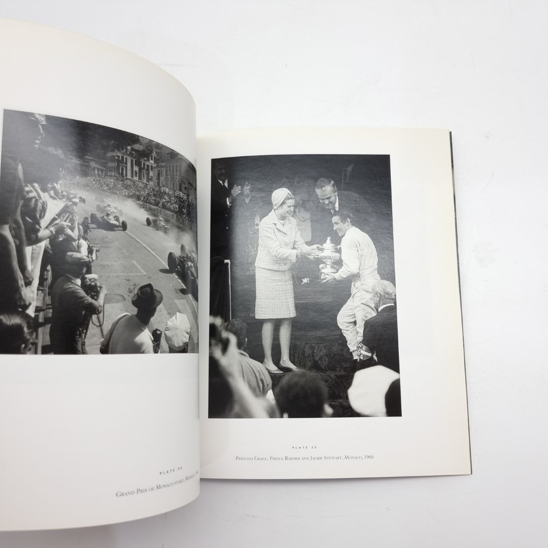 Motor racing photography book open with two black-and-white race event photos