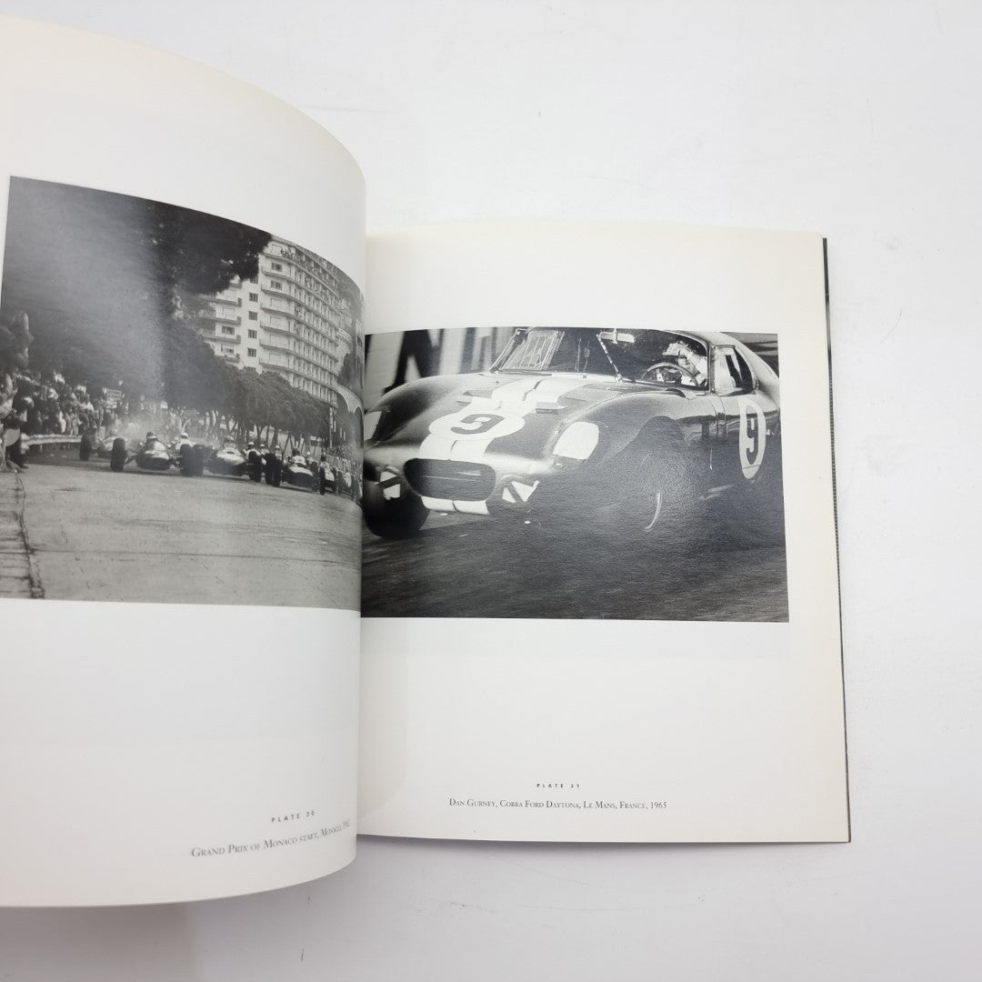 Motor racing photography book open with black-and-white sports car photo