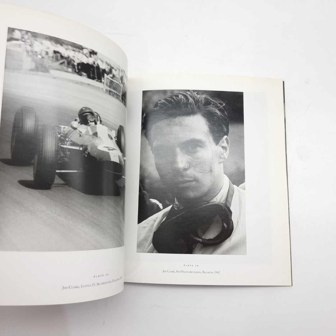Motor racing photography book open with black-and-white driver portrait and car image