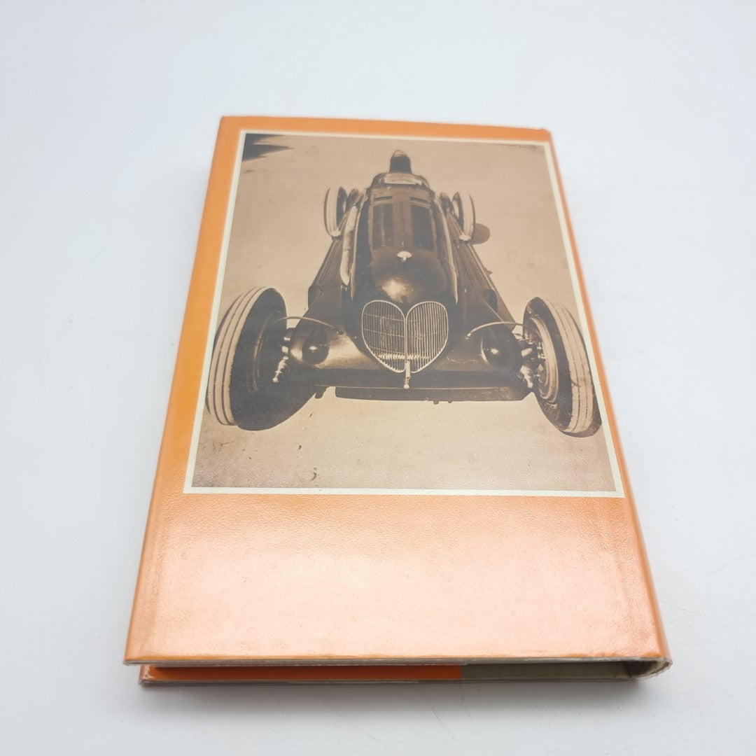 Motor Racing Mavericks book with orange cover and front view of a race car