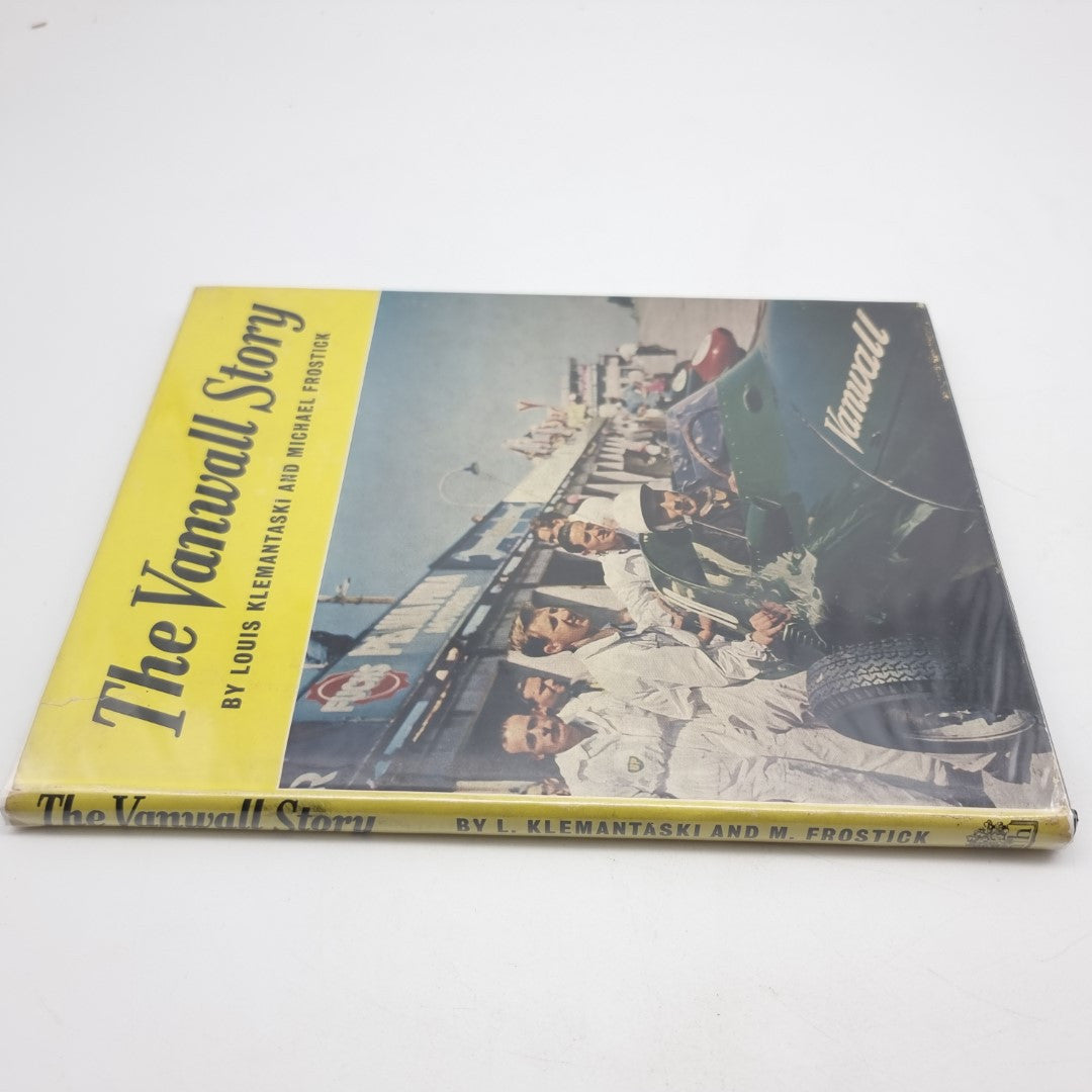 Vintage automotive book with yellow spine strip and racing team photo cover