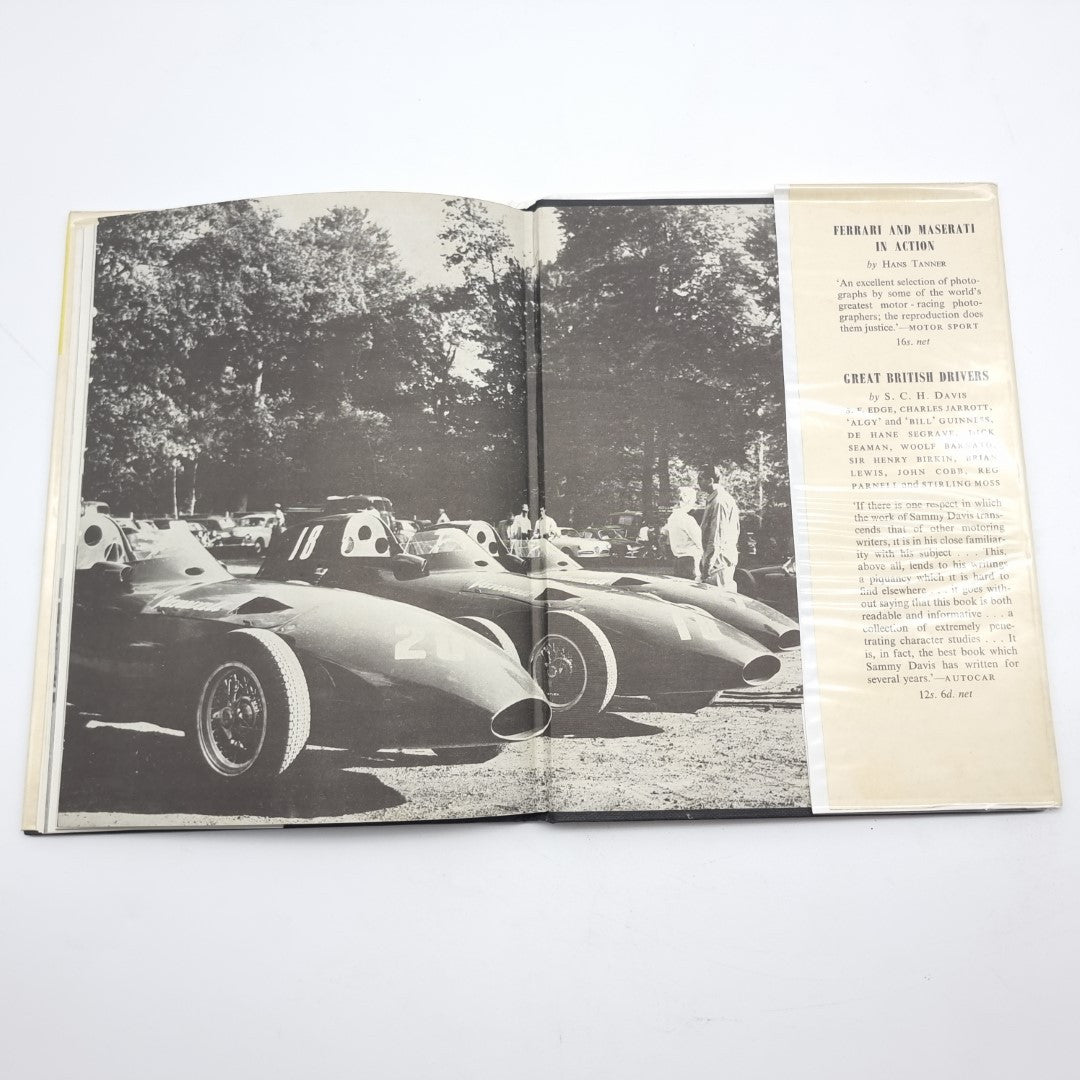 Vintage automotive book open to black-and-white race car photo with side column text