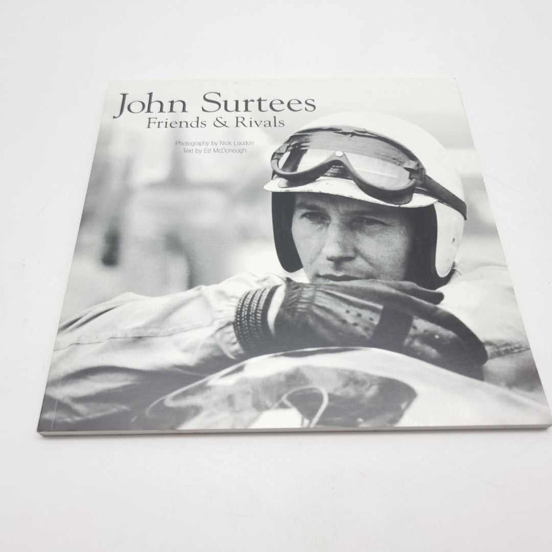 John Surtees Friends & Rivals black-and-white front cover photo with racing helmet