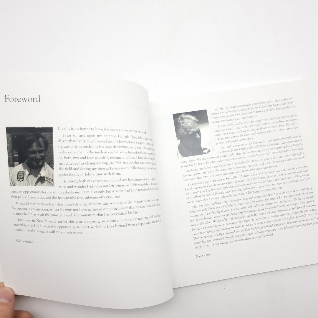 Open motorsport book pages with headings and paragraphs plus a small portrait