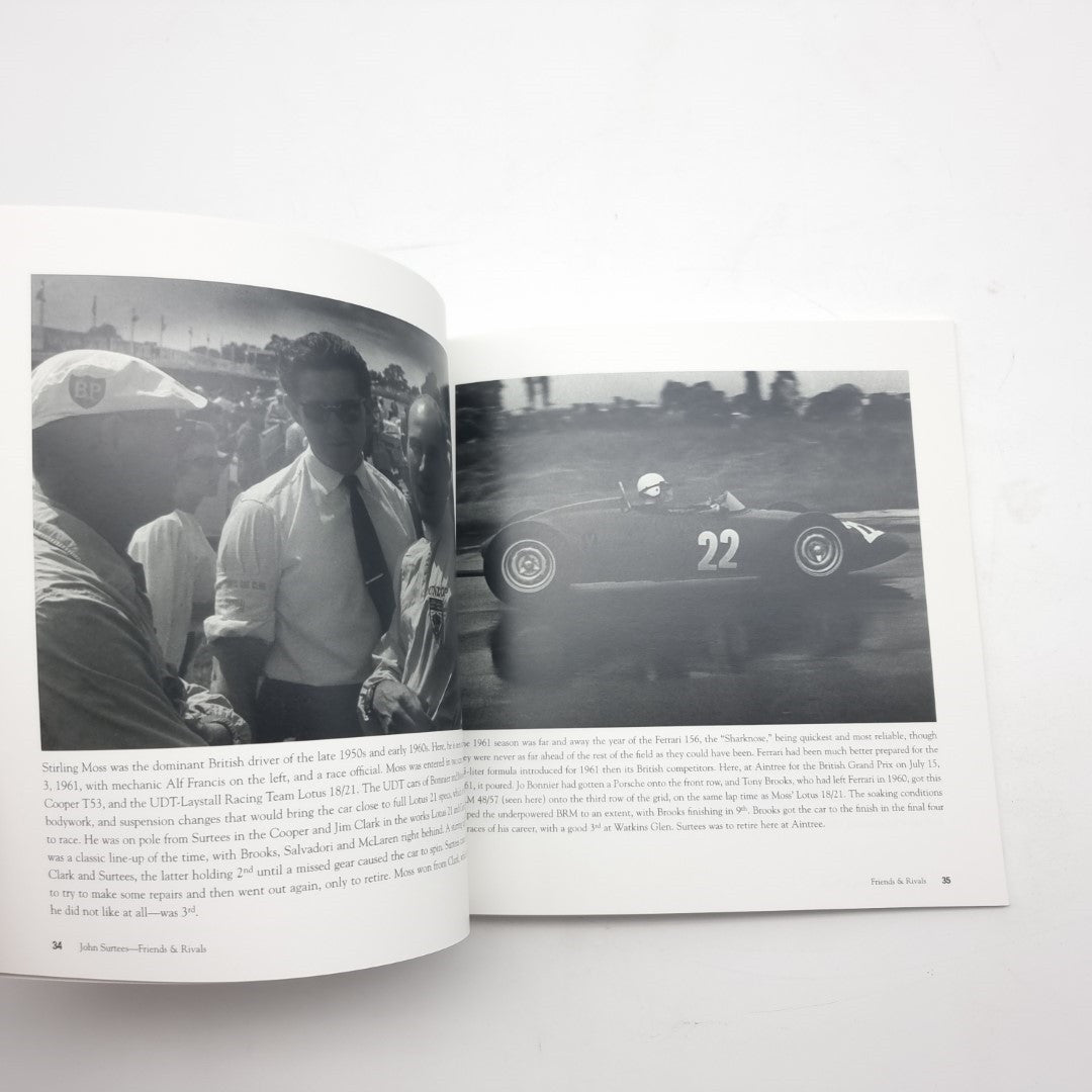 Open motorsport photo book with a driver portrait and a black-and-white race car