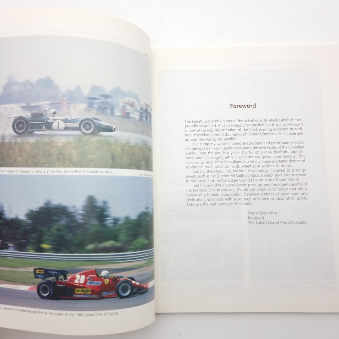 Open racing book pages with track photos and foreword text on the right