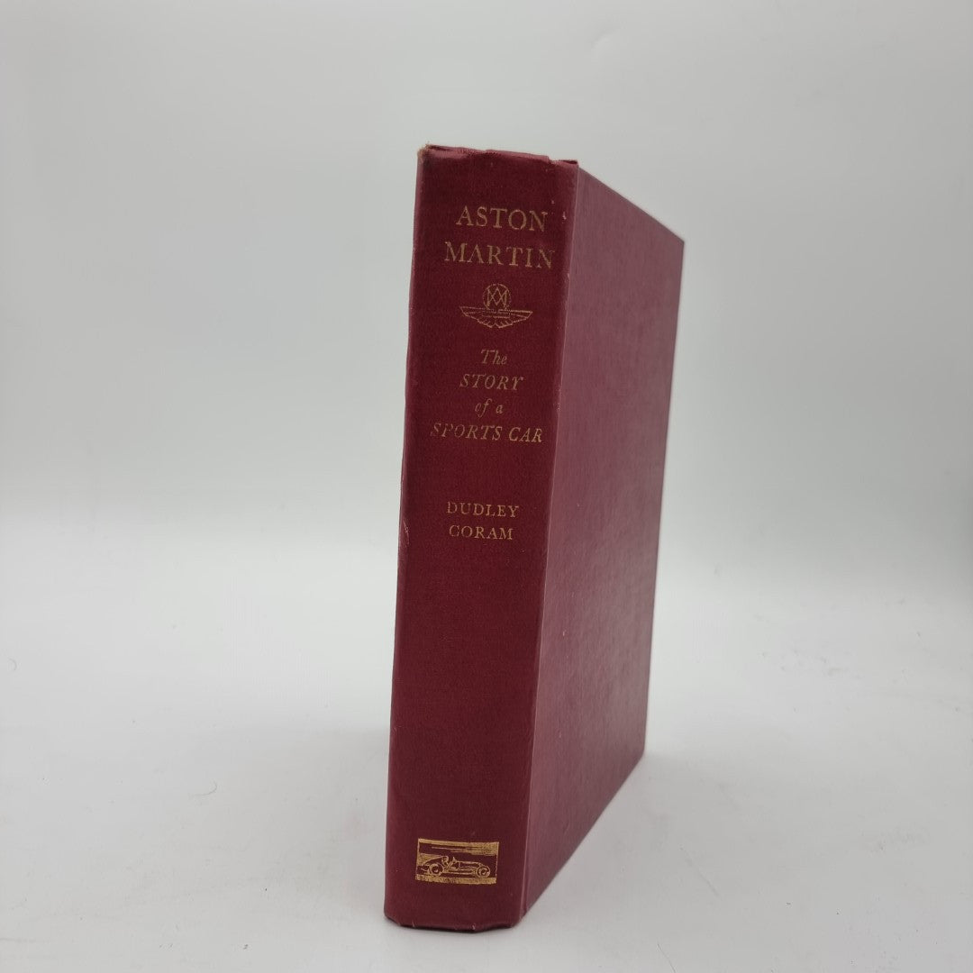 Maroon Aston Martin hardcover book standing upright, gold spine title text