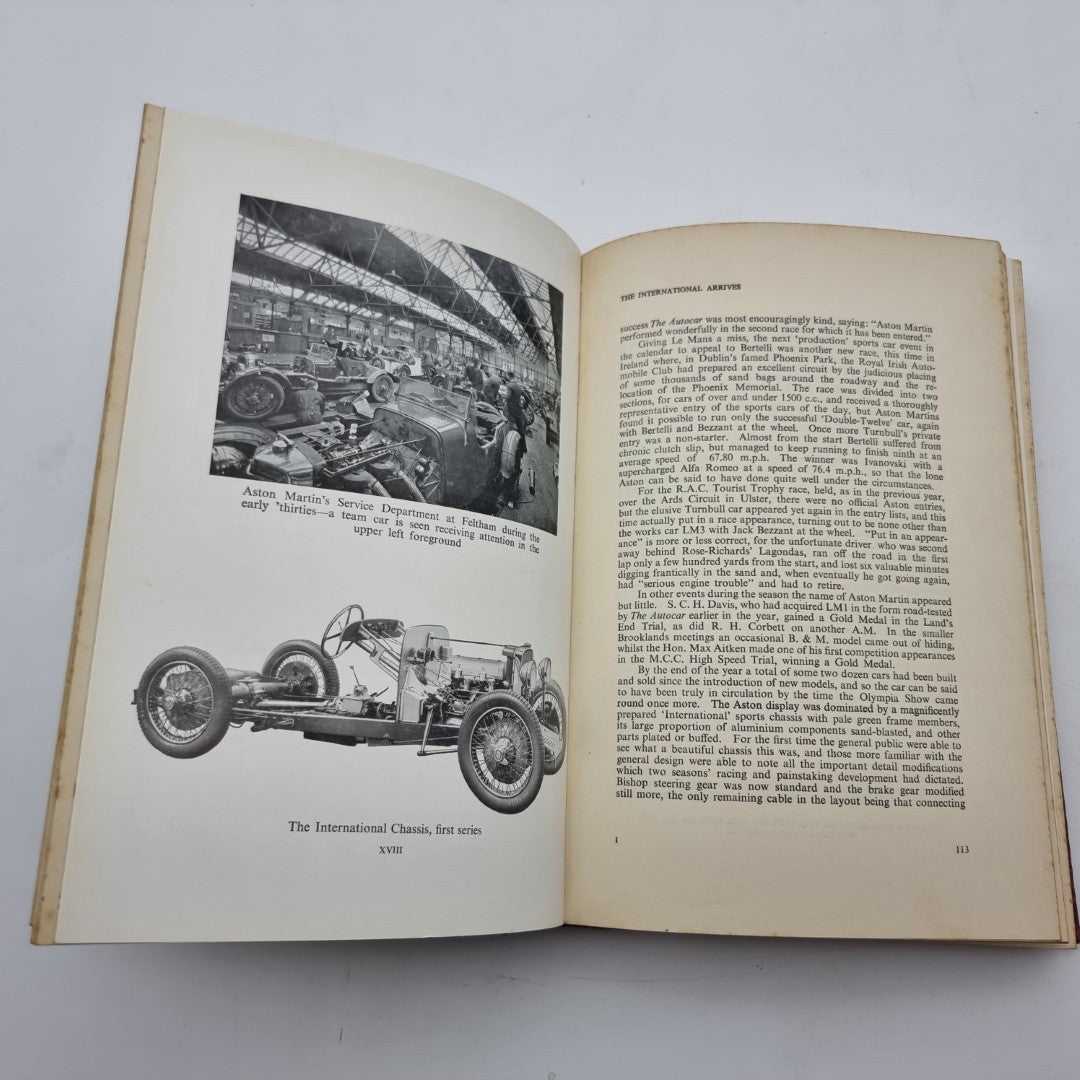 Open vintage book spread with race car photo and dense chapter text