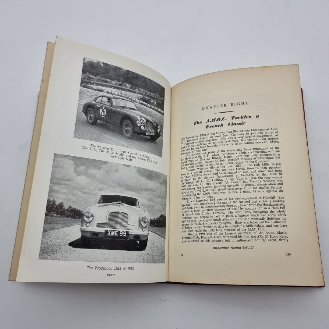 Open vintage book spread with classic car photos and chapter text