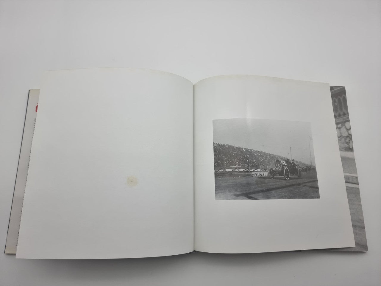 Open book showing a black-and-white race photo on the right page