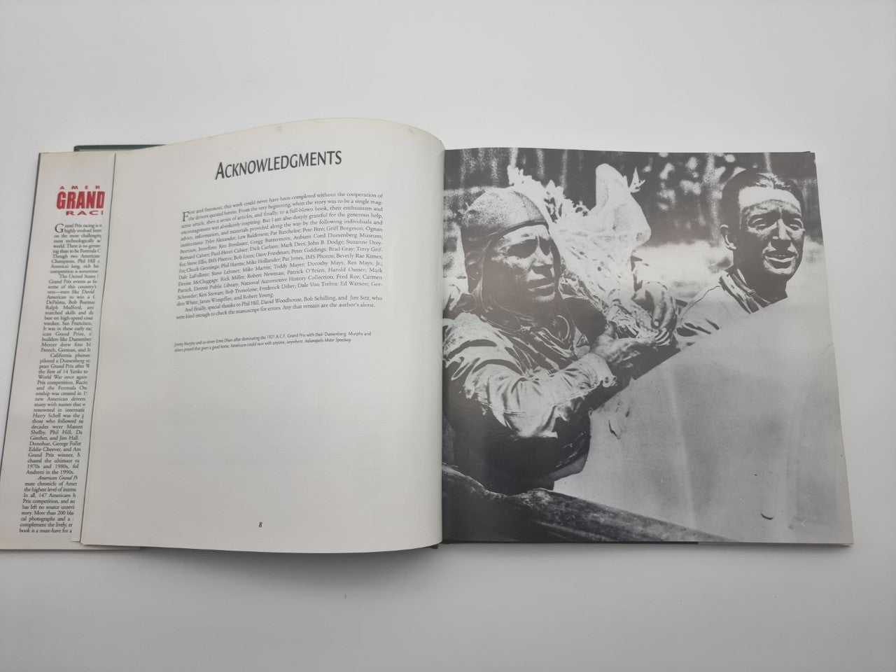Open book with "ACKNOWLEDGMENTS" page and black-and-white crowd photo