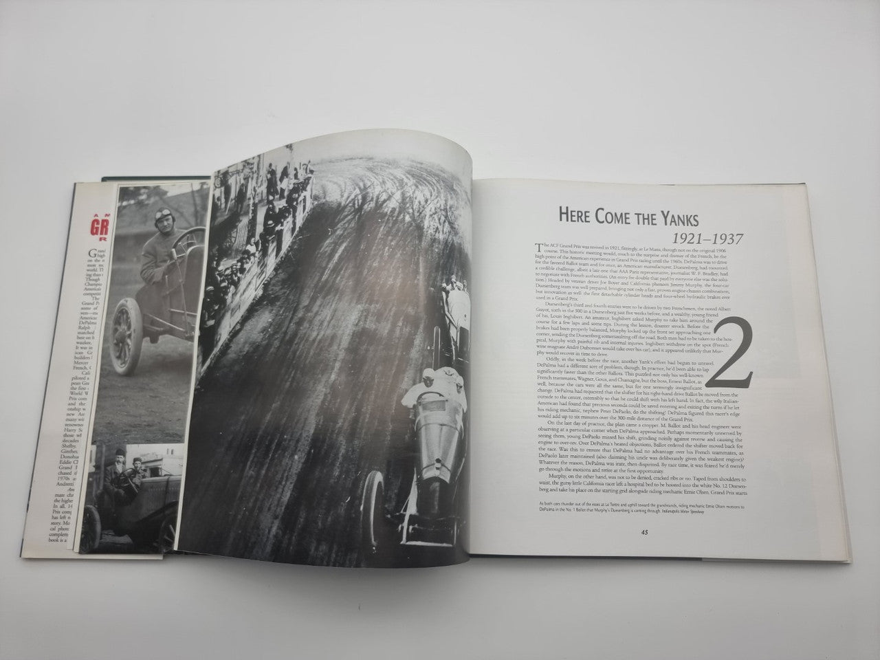 Racing history book, open spread with black-and-white car photo and numbered section