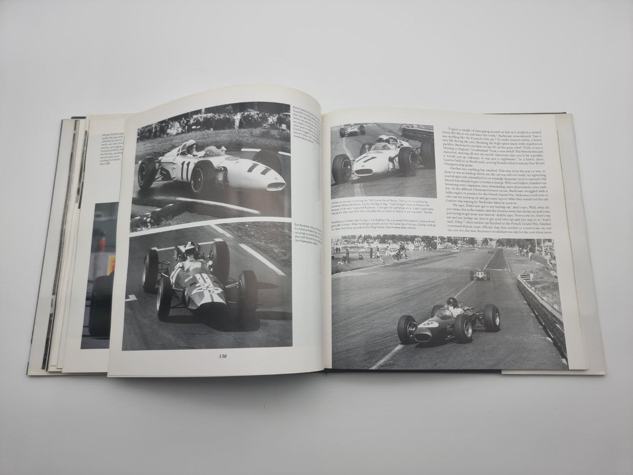 Open book with multiple black-and-white race car photos across both pages