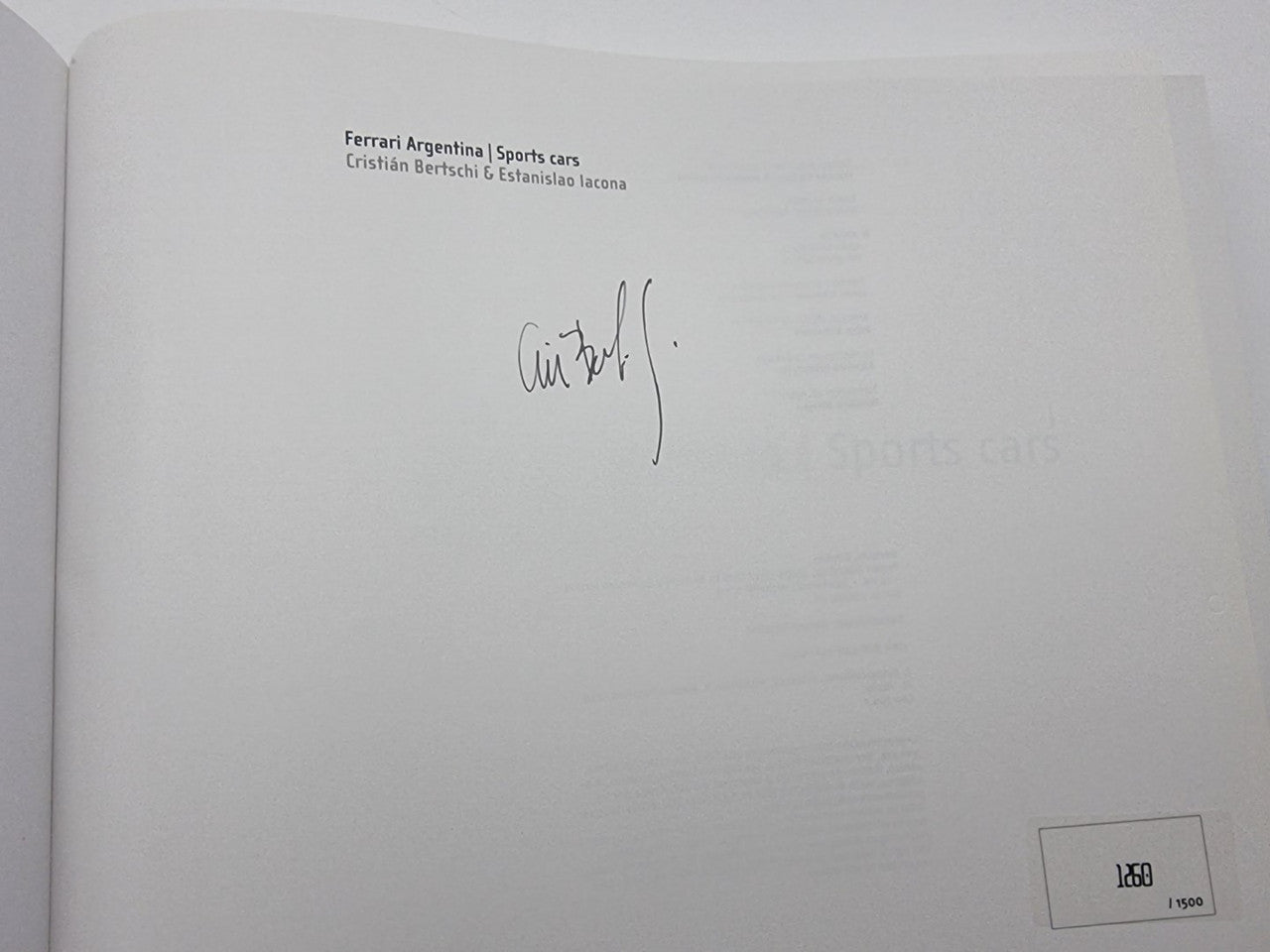 Signed book page with authors' names and a handwritten autograph