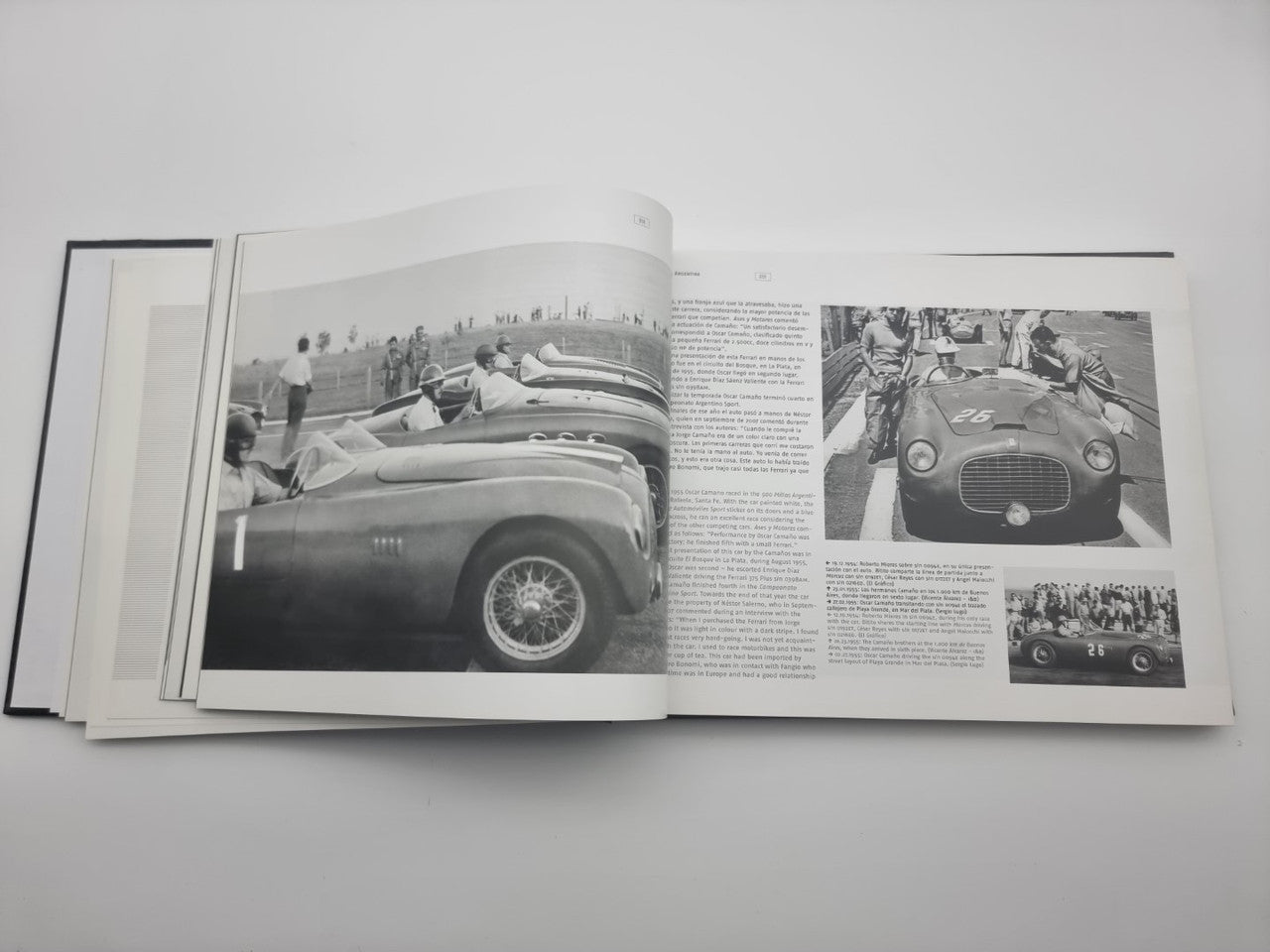 Signed sports car photo book open, showing classic race car photos