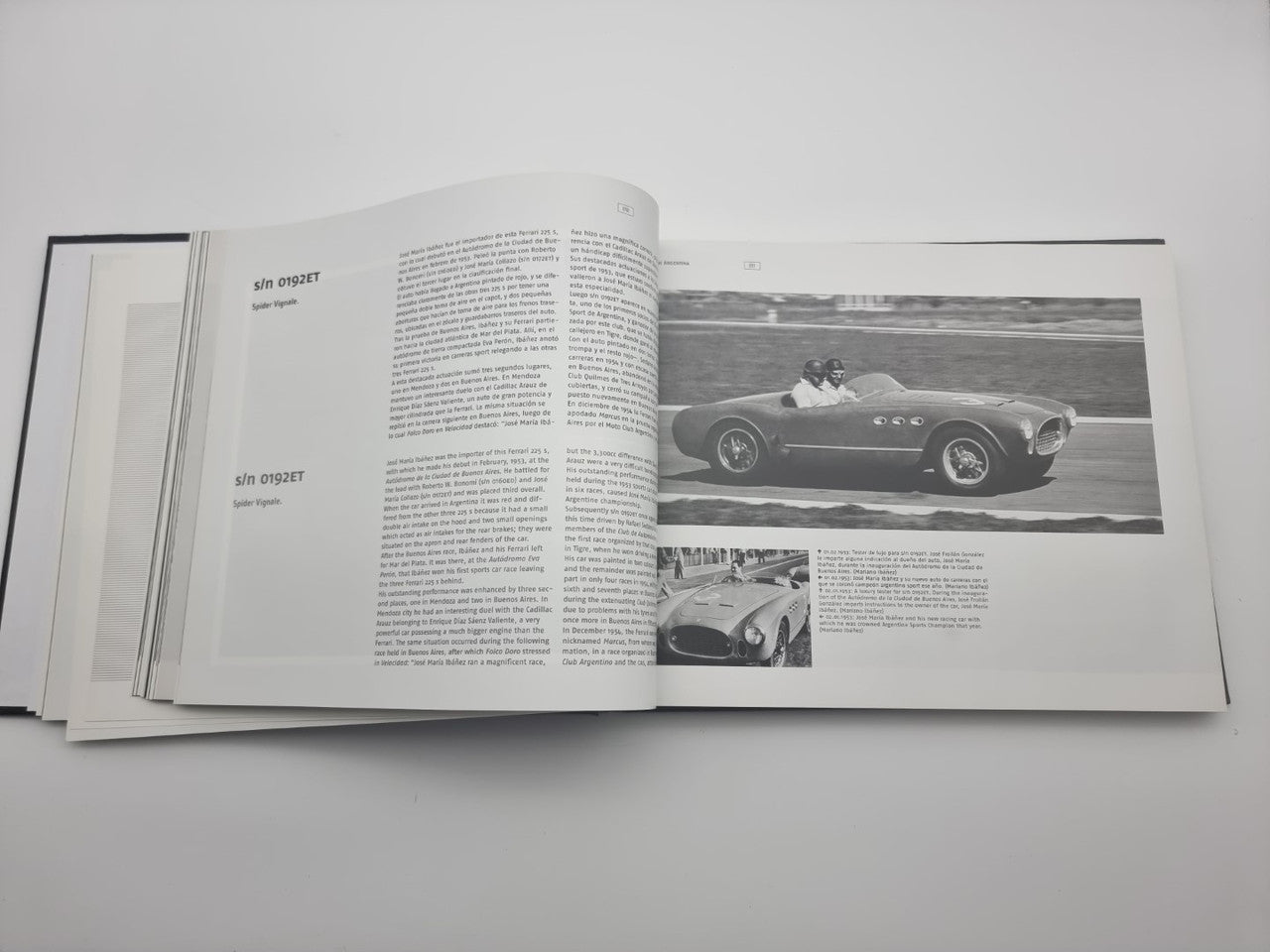 Signed sports car photo book open, featuring a driver in a vintage race car