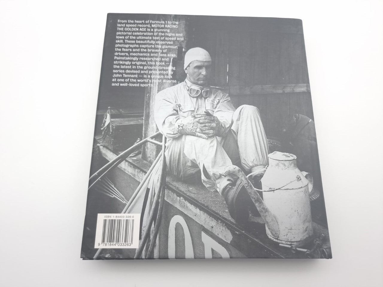 Motor racing photo book back cover with seated man and barcode