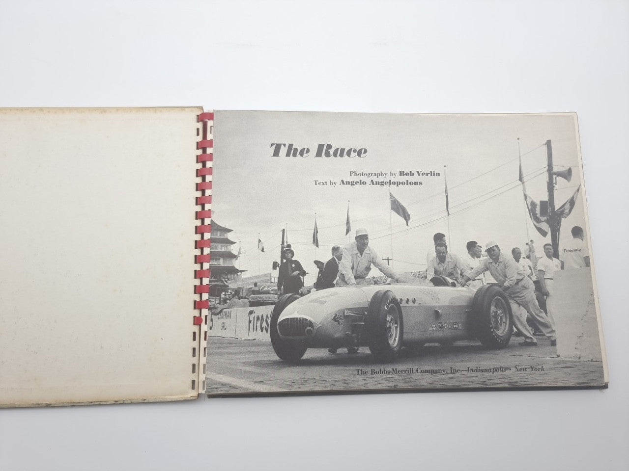 Open book spread with title 'The Race' and vintage race car photo.