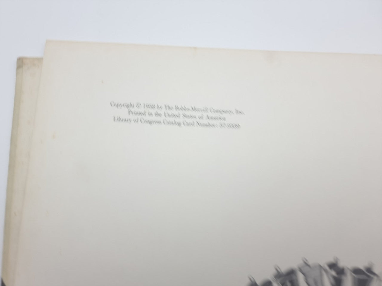 Book page with small printed text on an off-white background.
