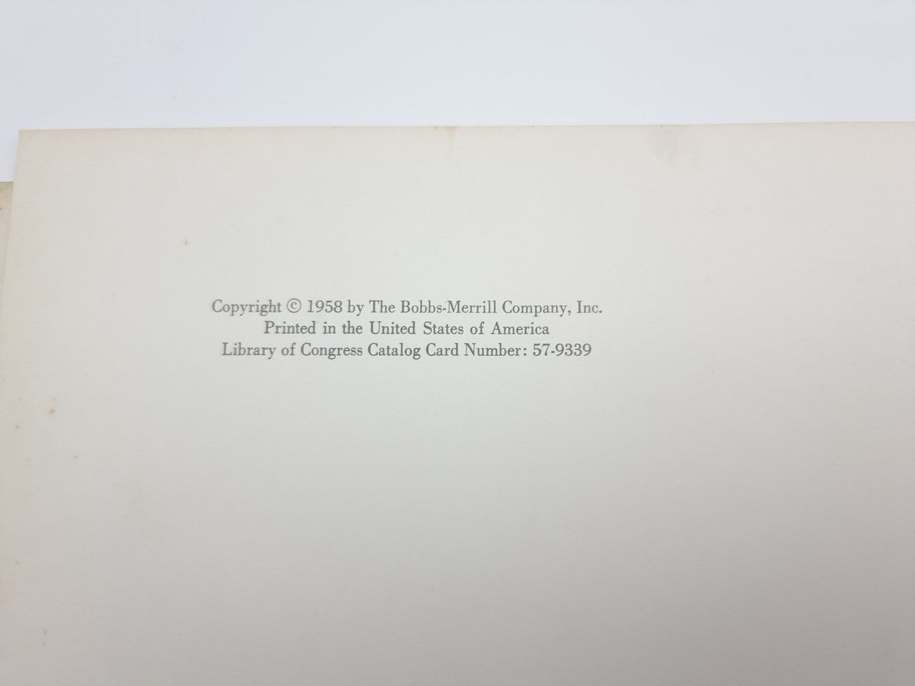 Book page with copyright text printed near the center on off-white paper.