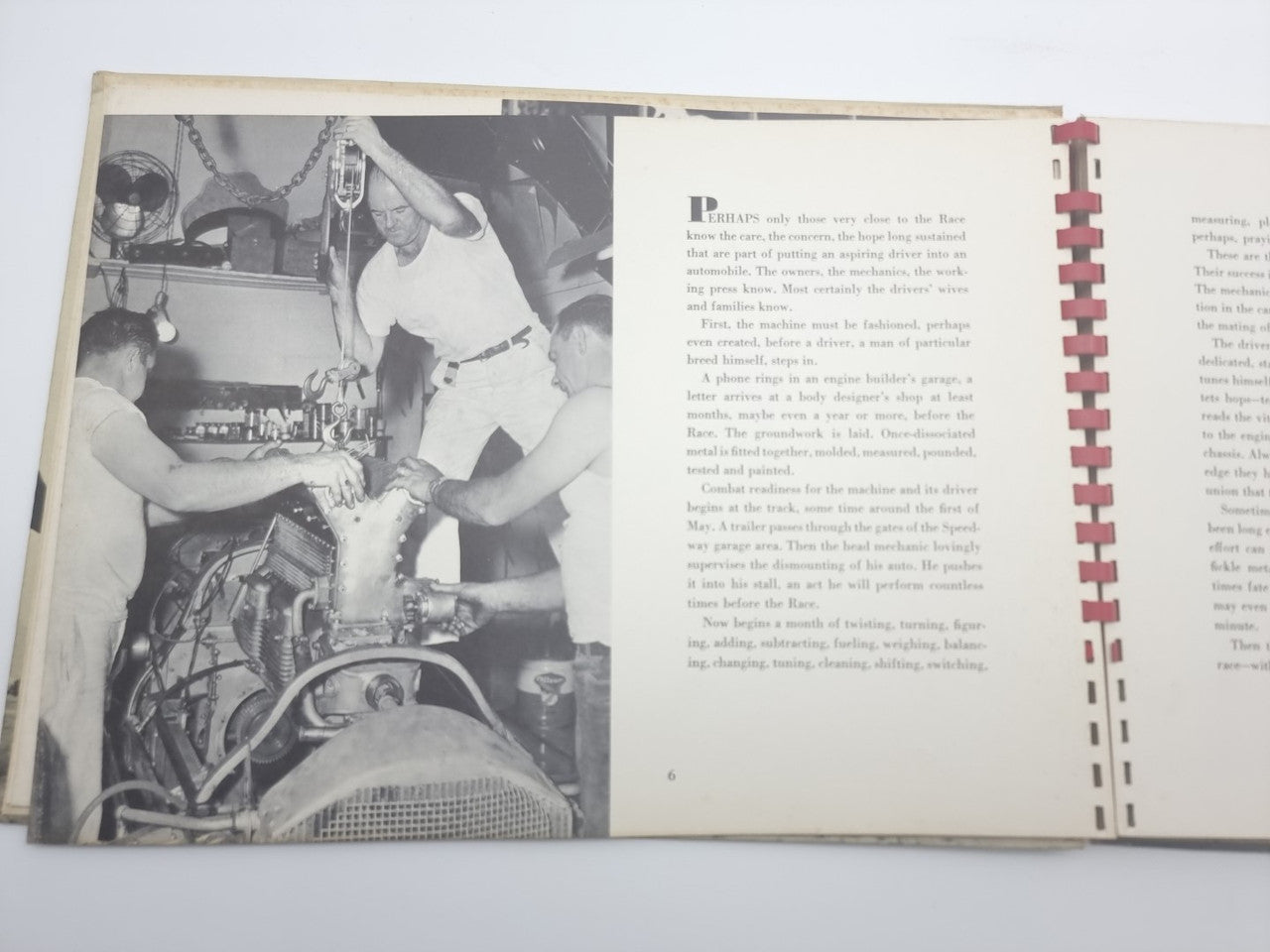 Open book spread with large black-and-white photo and printed text on right page.