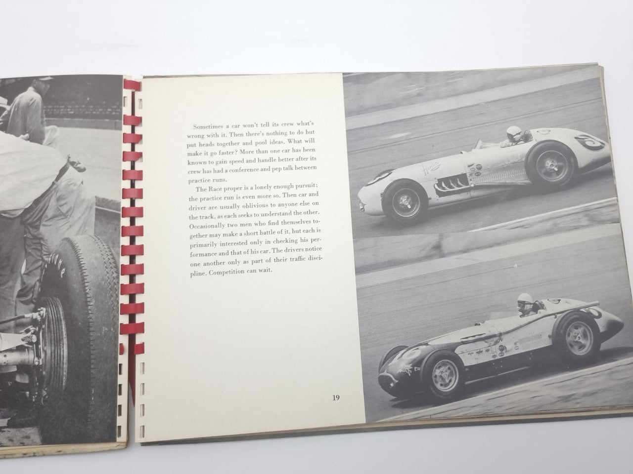 Open book page spread with vintage race car photos and printed text