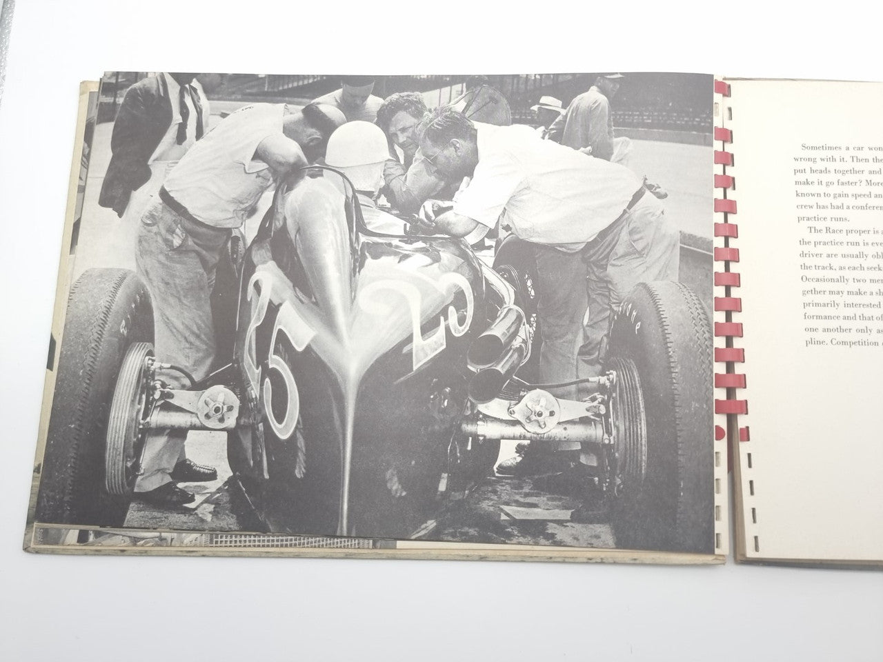Open book spread with crowd scene and vintage car racing photos, plus sidebar text