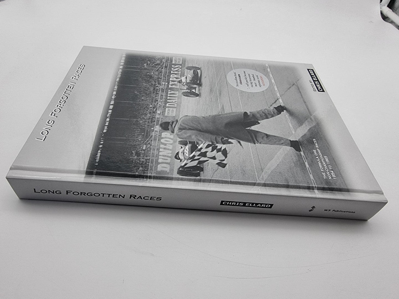 Hardcover motorsport racing history book with cover photo and title on front
