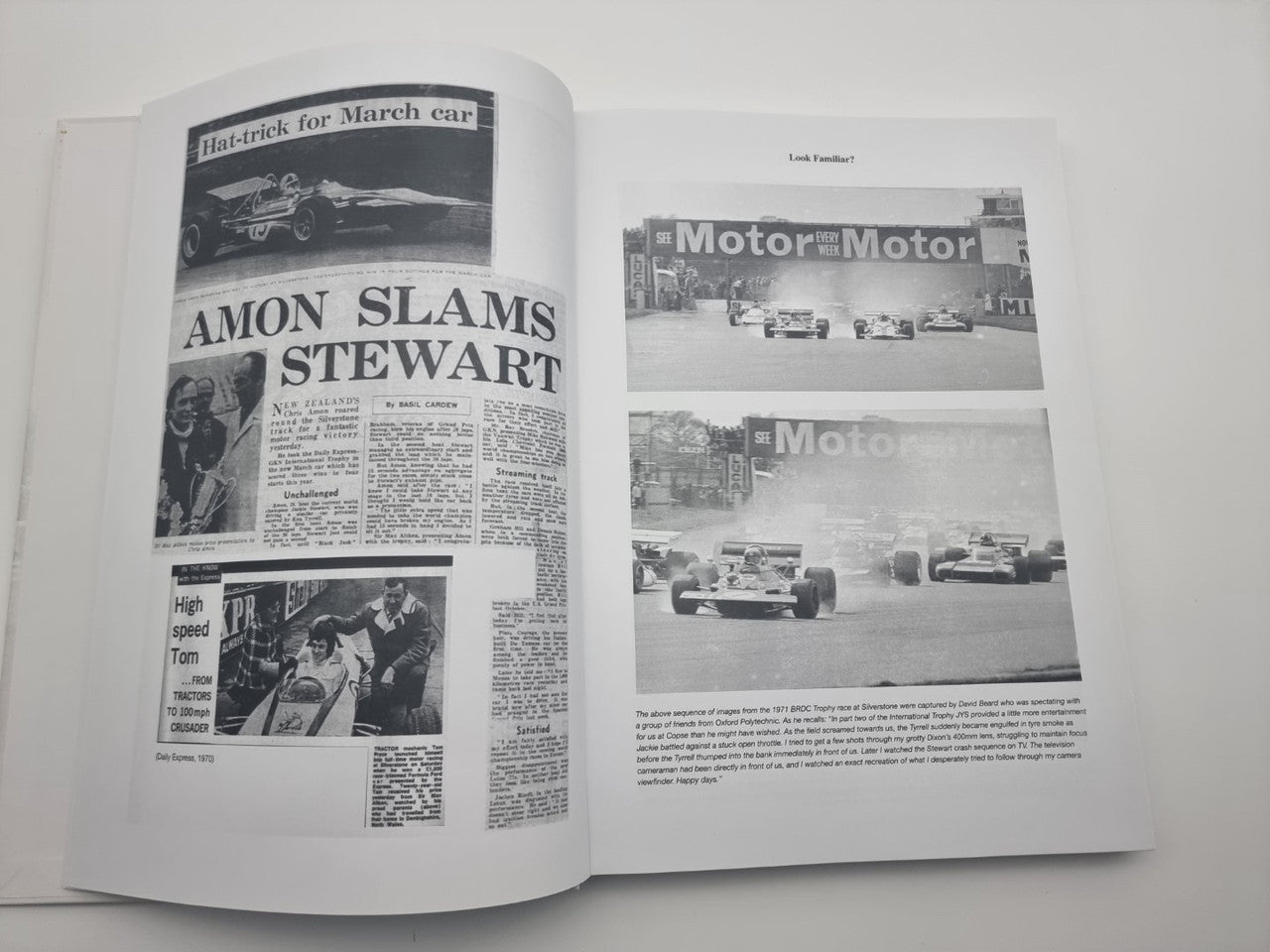 Race history book open, newspaper-style pages with racing images and bold headlines