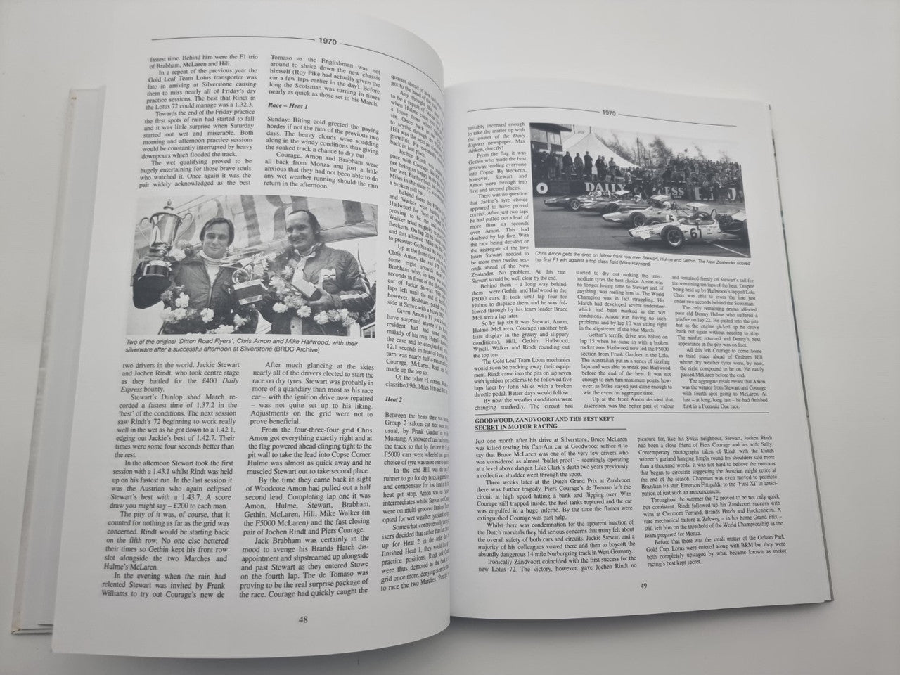 Race history book open to photo and text pages with two men at race event